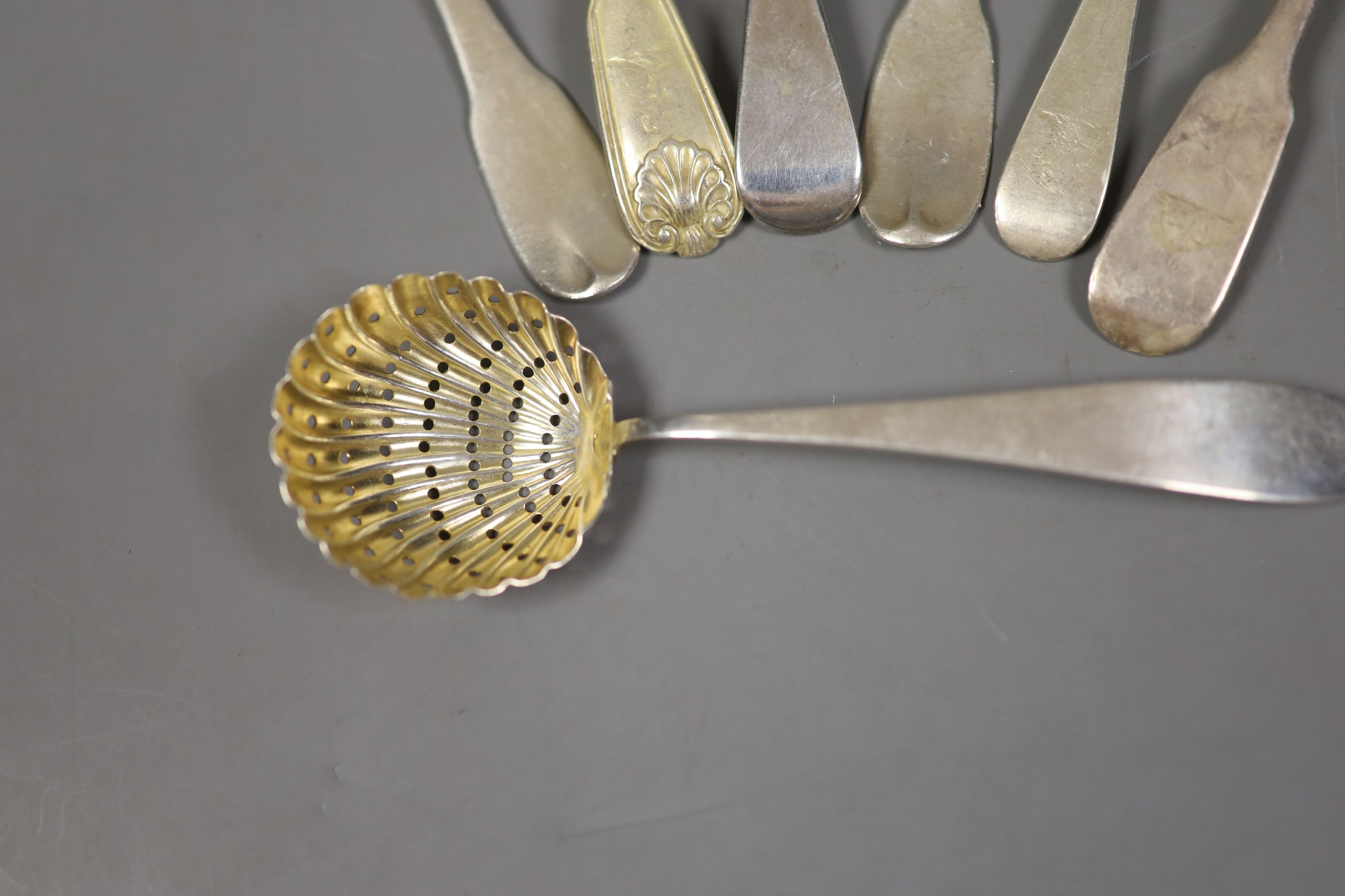 Seven assorted 19th century silver spoons including teaspoons and a sifter spoon, various dates and makers